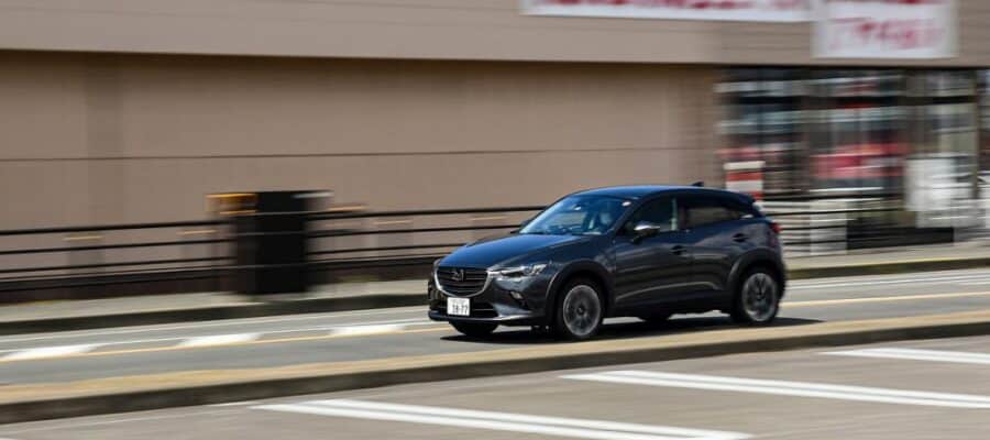 Black compact SUV driving on an urban road