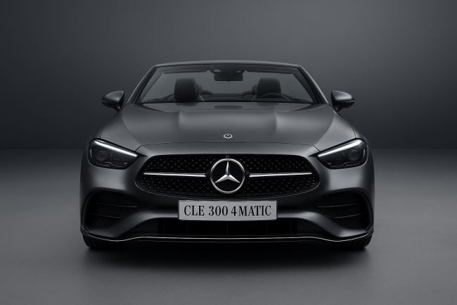 Front view of a Mercedes-Benz CLE 300 4MATIC Cabriolet showcased in a studio setting, with a sleek metallic finish and a refined gray gradient background highlighting its luxury design.