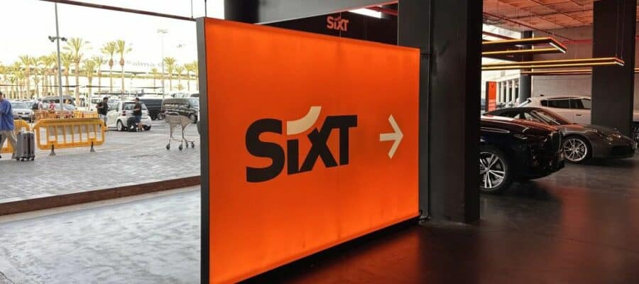 Sixt airport car hire sign pointing to rental pickup area